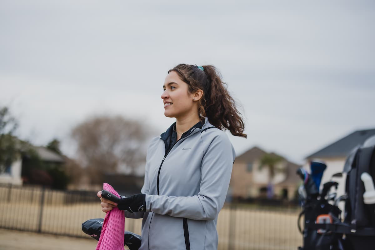 Woman Golfing During a Windy Day